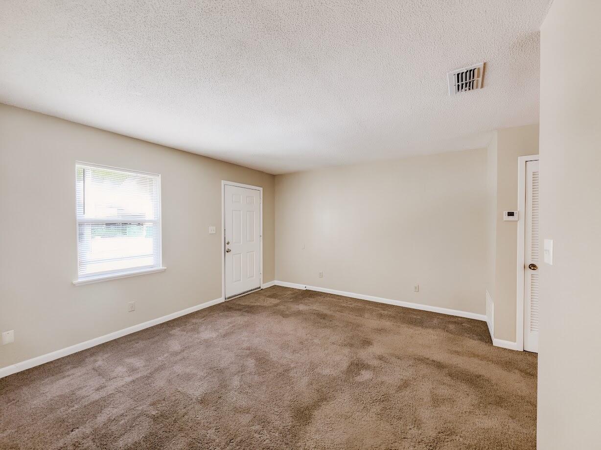 208 Squirrel Haven Road, Unit A Mary Esther, FL 32569 - Photo 5 of 16 an empty room with windows