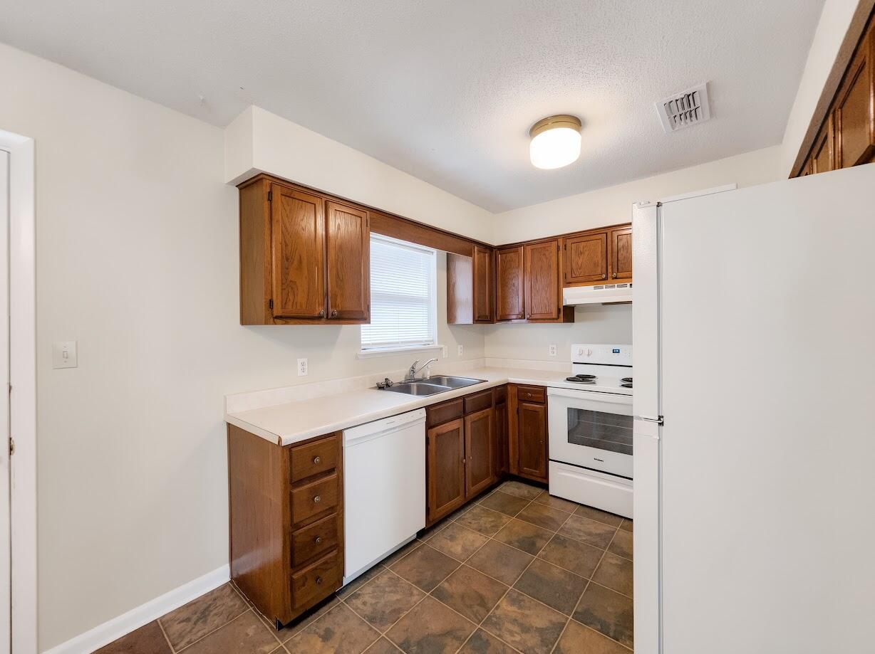 208 Squirrel Haven Road, Unit A Mary Esther, FL 32569 - Photo 7 of 16 a kitchen with stainless steel appliances granite countertop a stove a sink dishwasher and a refrigerator