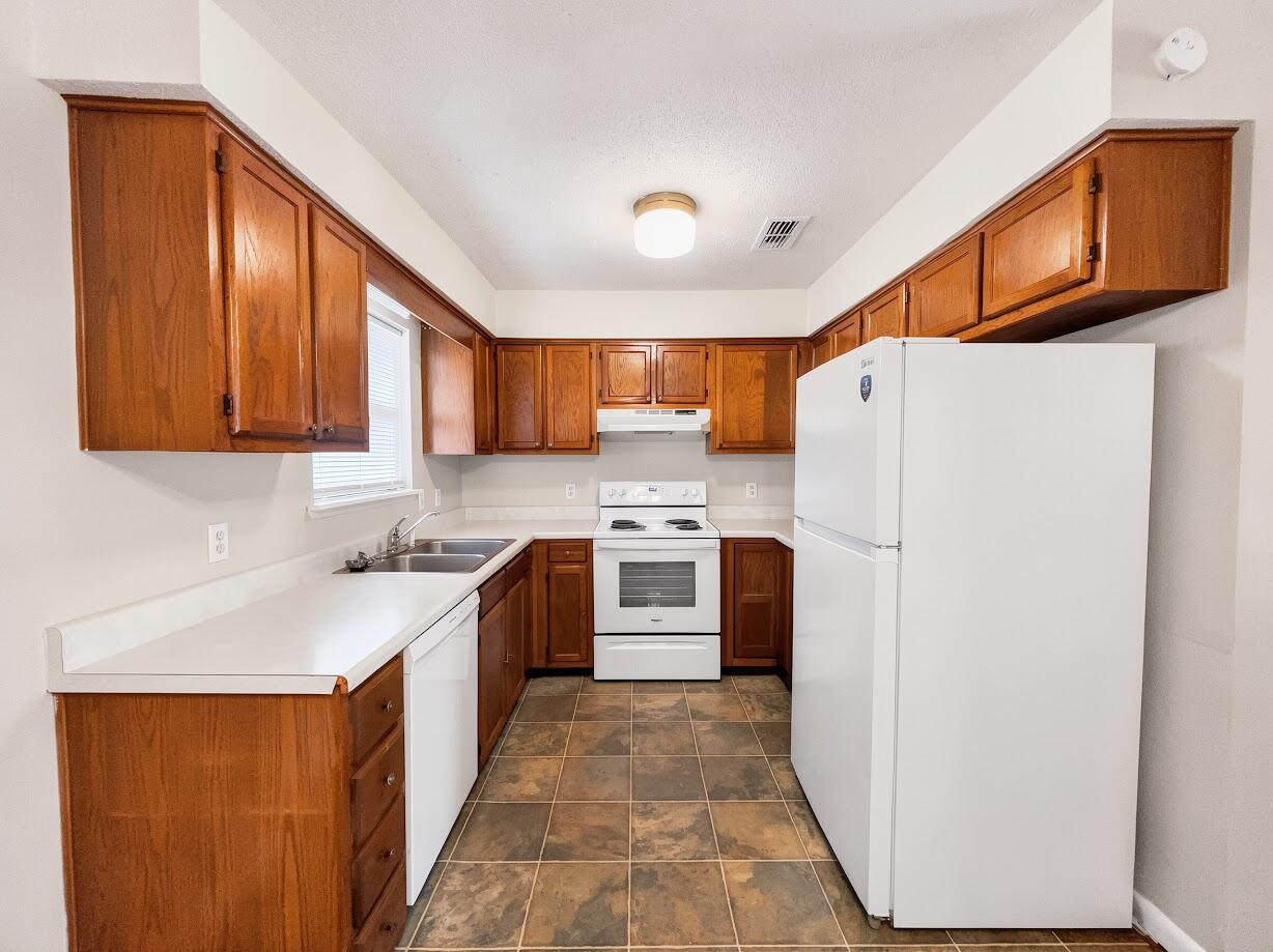 208 Squirrel Haven Road, Unit A Mary Esther, FL 32569 - Photo 8 of 16 a kitchen with a refrigerator sink and cabinets