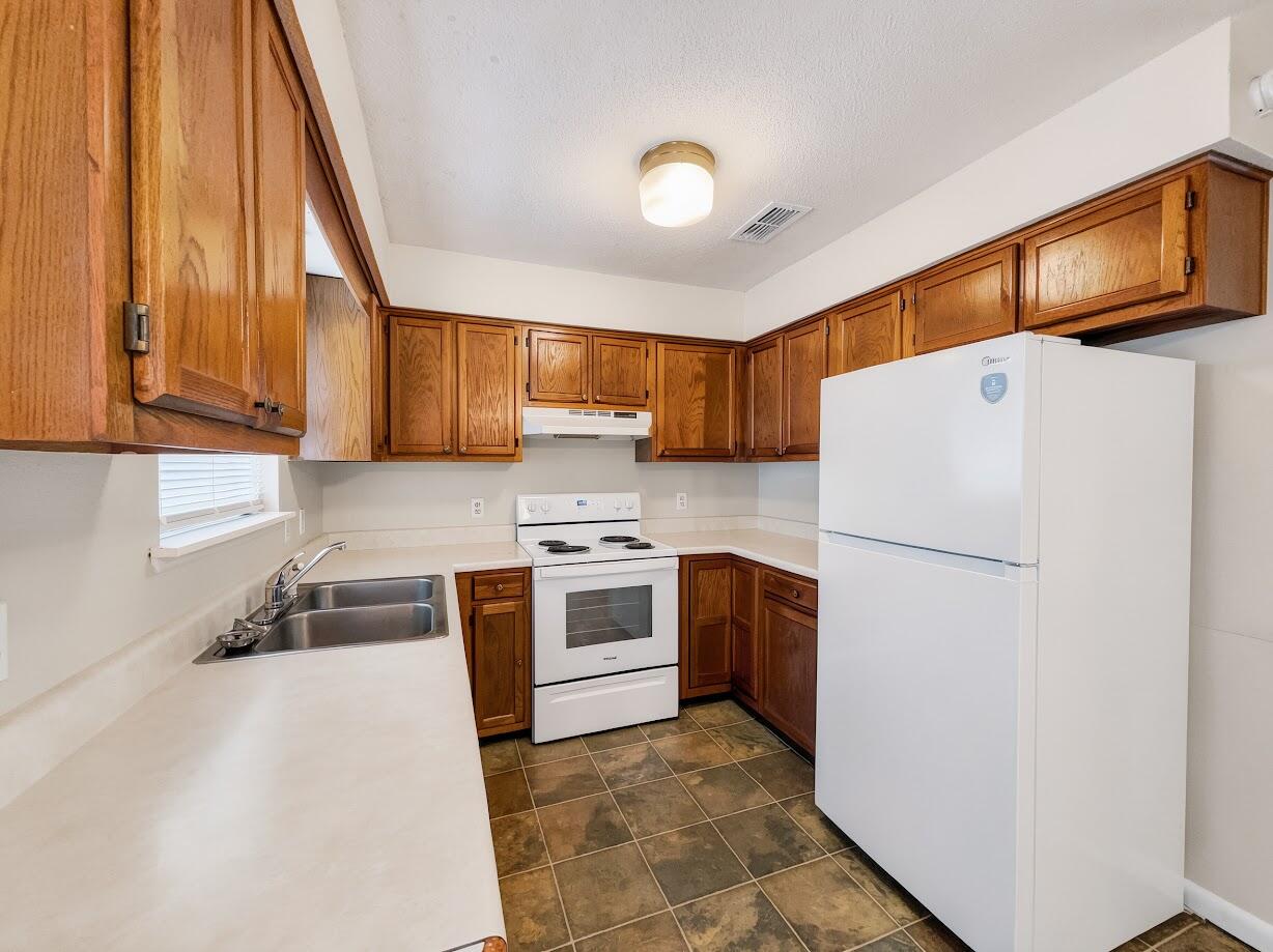 208 Squirrel Haven Road, Unit A Mary Esther, FL 32569 - Photo 9 of 16 a kitchen with stainless steel appliances granite countertop a refrigerator a stove a sink and a microwave