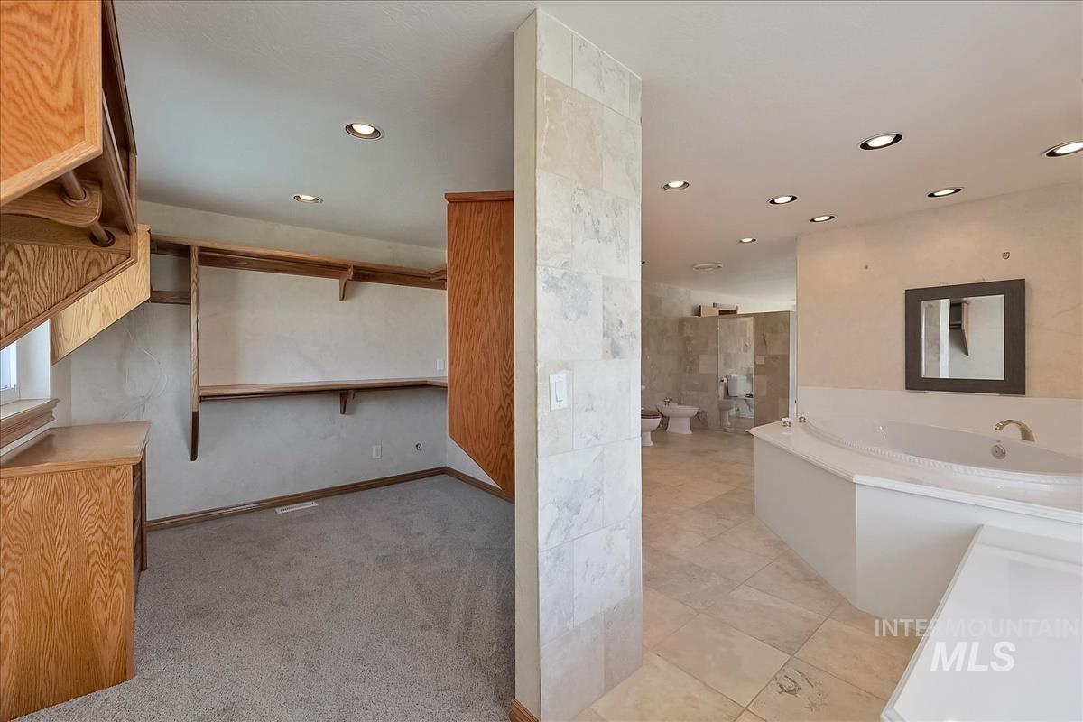 2804 West Sunrise Rim Road Boise, ID 83705 - Photo 40 of 50 Expansive bathroom featuring a built-in jetted tub, ceramic tile flooring, and recessed lighting