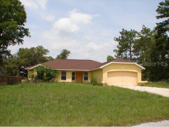 5249 Southwest 155th Loop Ocala, FL 34473 - Photo 1 of 1 a front view of a house with a garden