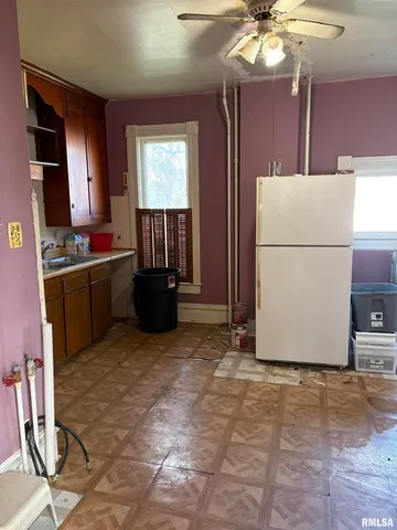 a view of kitchen with furniture and refrigerator