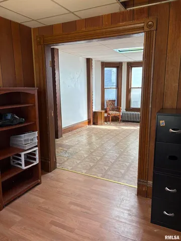 a view of a livingroom with wooden floor and furniture