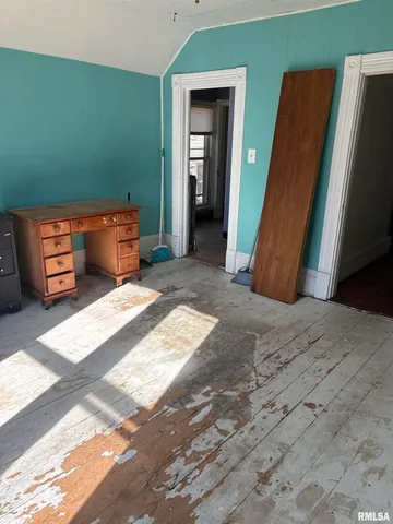 a view of a bedroom with furniture and closet