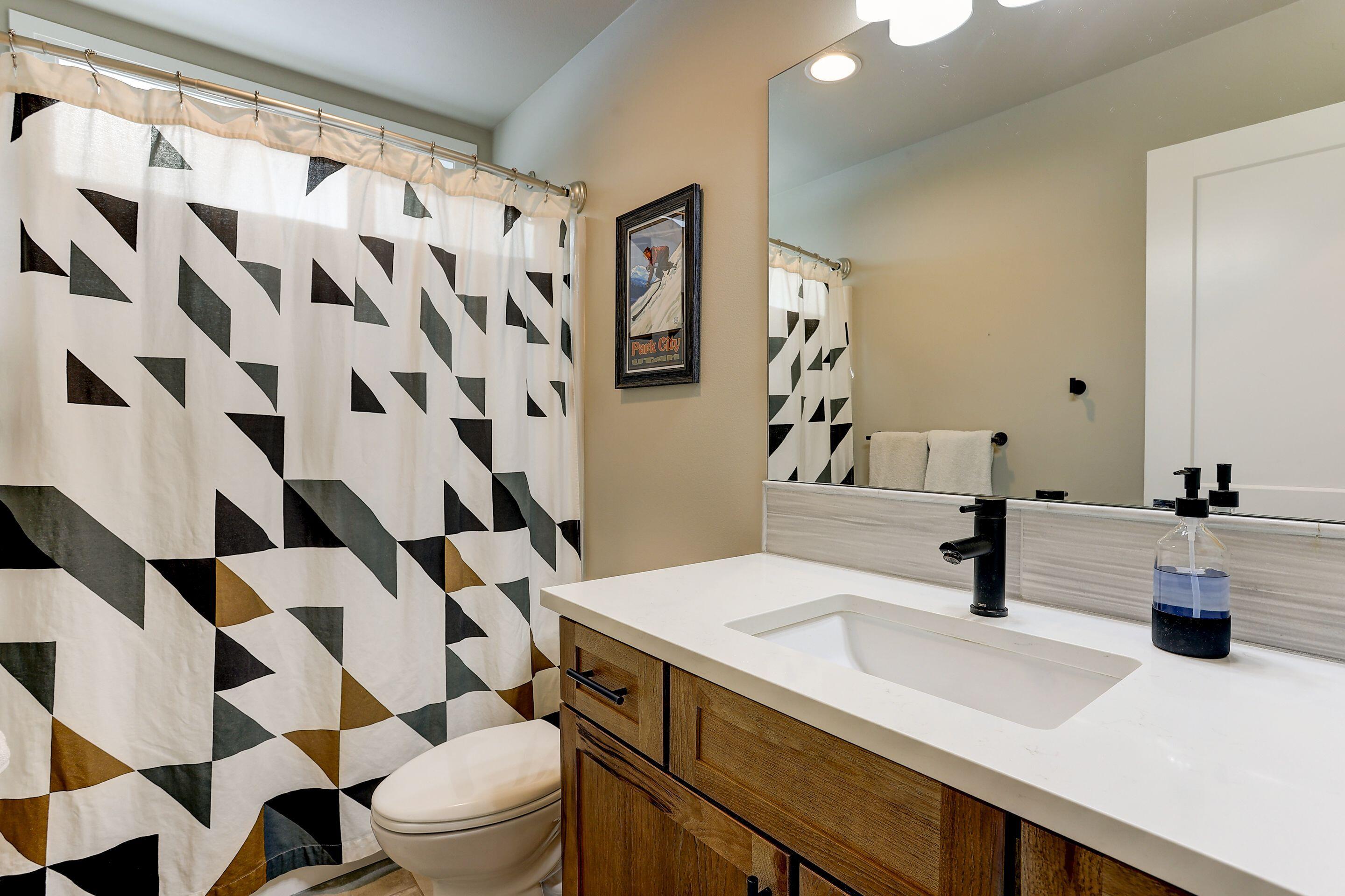 19047 Pumice Butte Road Bend, OR 97702 - Photo 35 of 38 a bathroom with a sink a toilet and shower curtain