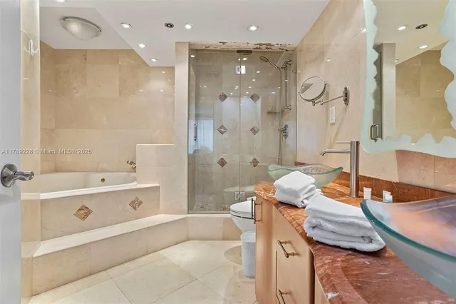 a bathroom with a tub sink and mirror