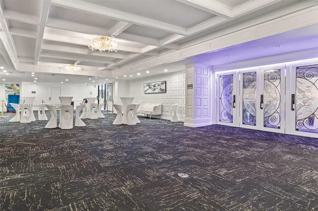 a view of a room with lots of white furniture