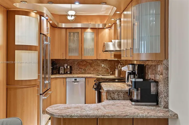 a kitchen with a refrigerator a sink and wooden cabinets
