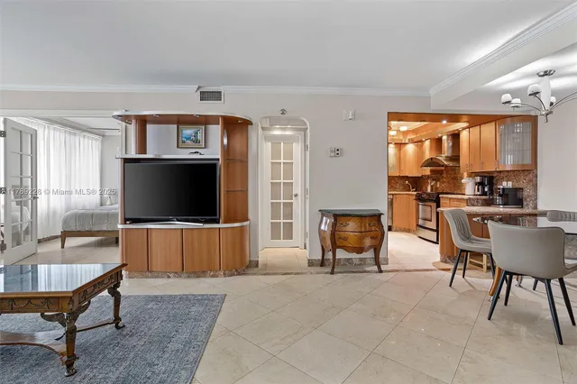 a living room with furniture a flat screen tv and a large window