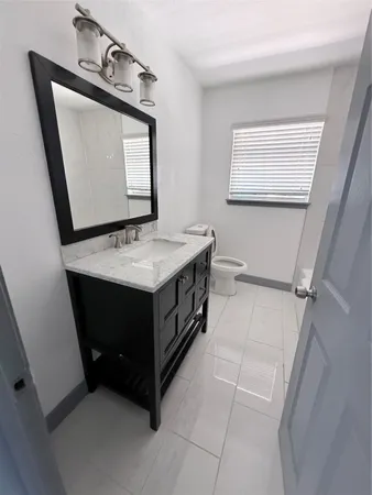 a bathroom with a sink vanity and mirror