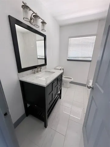 a bathroom with a sink vanity and mirror