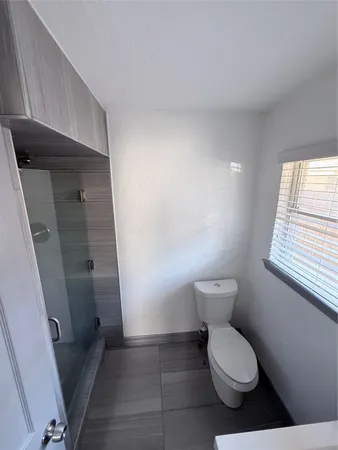 a bathroom with a toilet and a shower
