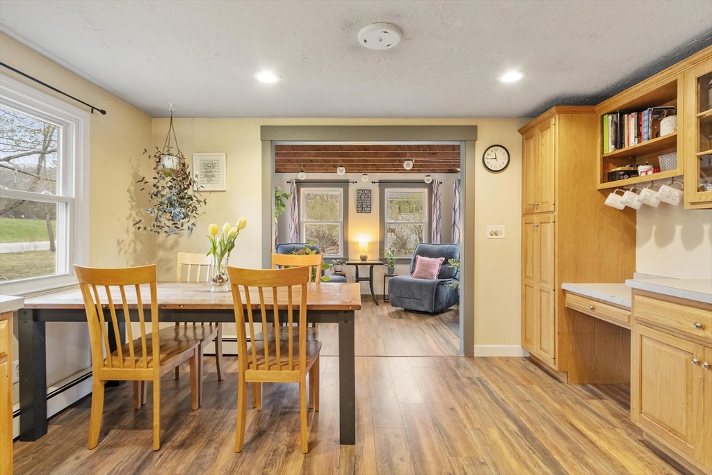 101 Williams Road Ashburnham, MA 01430 - Photo 19 of 42 a living room with furniture a fireplace and a dining table with wooden floor