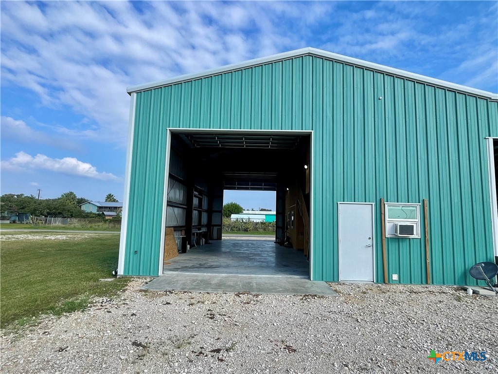211 5th Street Port O'Connor, TX 77982 - Photo 19 of 22 a front view of a house with a garden