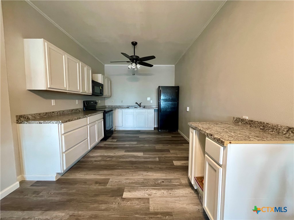 211 5th Street Port O'Connor, TX 77982 - Photo 2 of 22 a kitchen with stainless steel appliances granite countertop a sink and a refrigerator