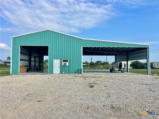 a view of a house with a yard and garage
