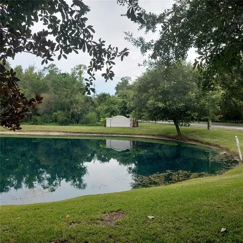 a view of a golf course with a lake view