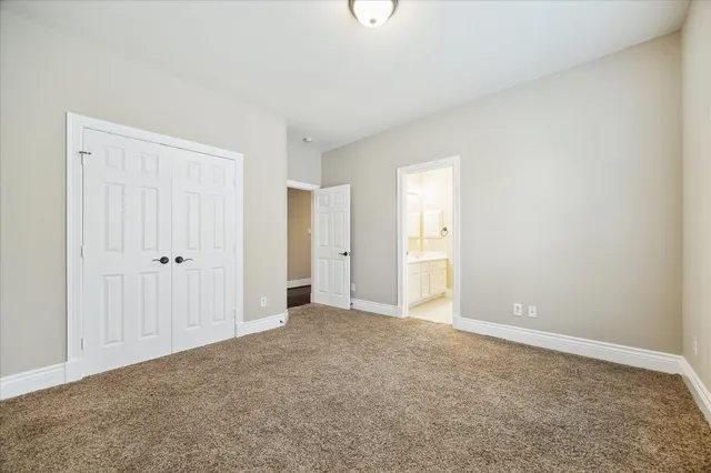 a view of an empty room with closet area