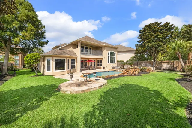 a front view of a house with a garden and patio
