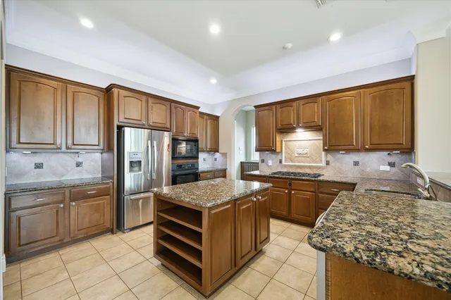 a kitchen with a stove sink and refrigerator
