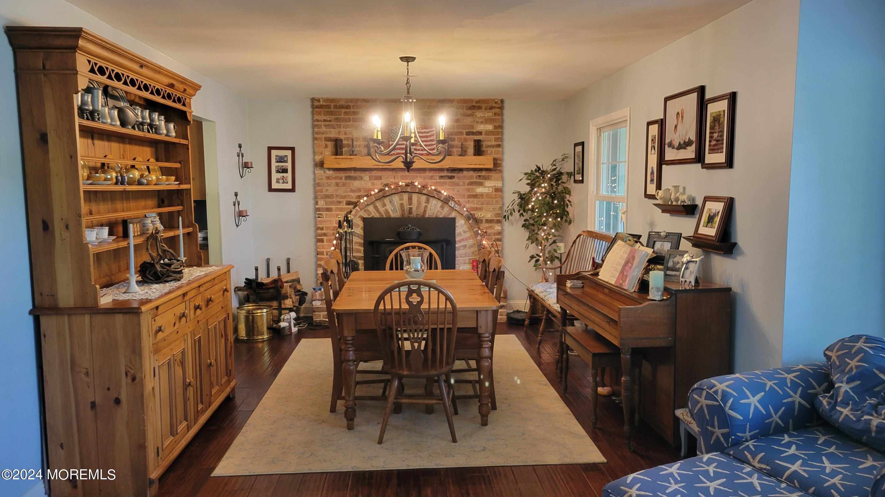 15 Bock Boulevard Howell, NJ 07731 - Photo 3 of 21 a living room with furniture a chandelier and a fireplace