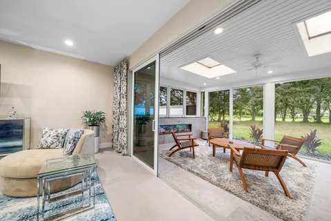 a living room with furniture and large windows