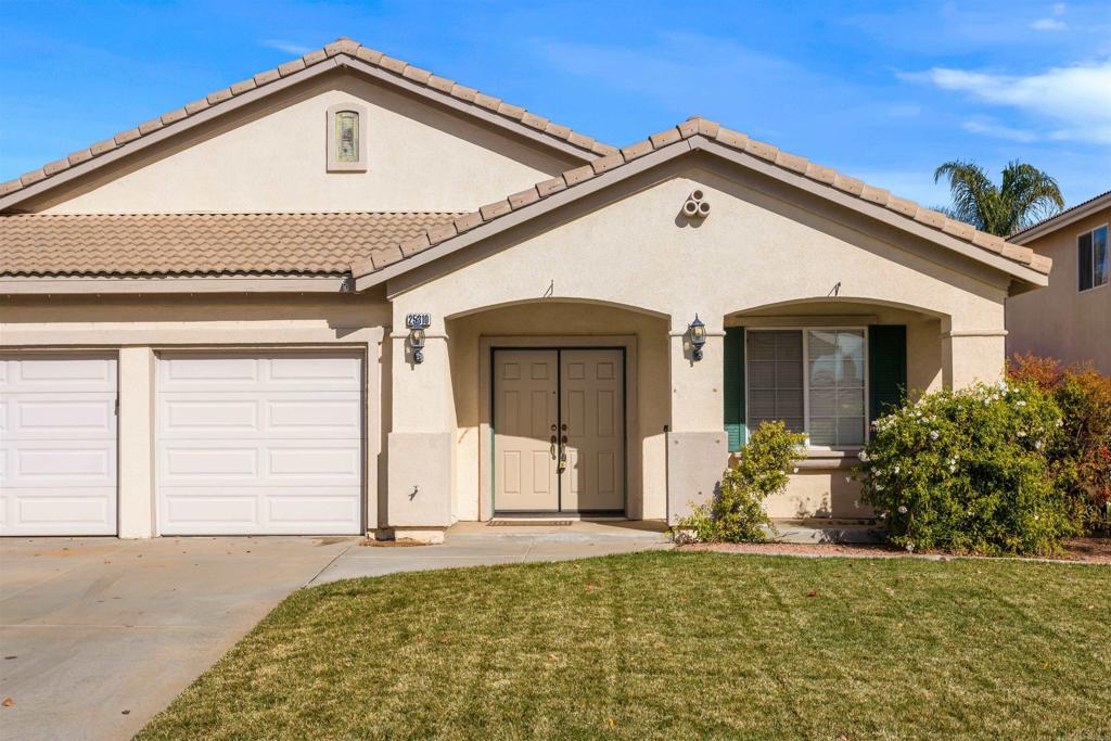 25310 Forest Wood Circle Menifee, CA 92584 - Photo 6 of 6 a front view of a house with a yard and garage