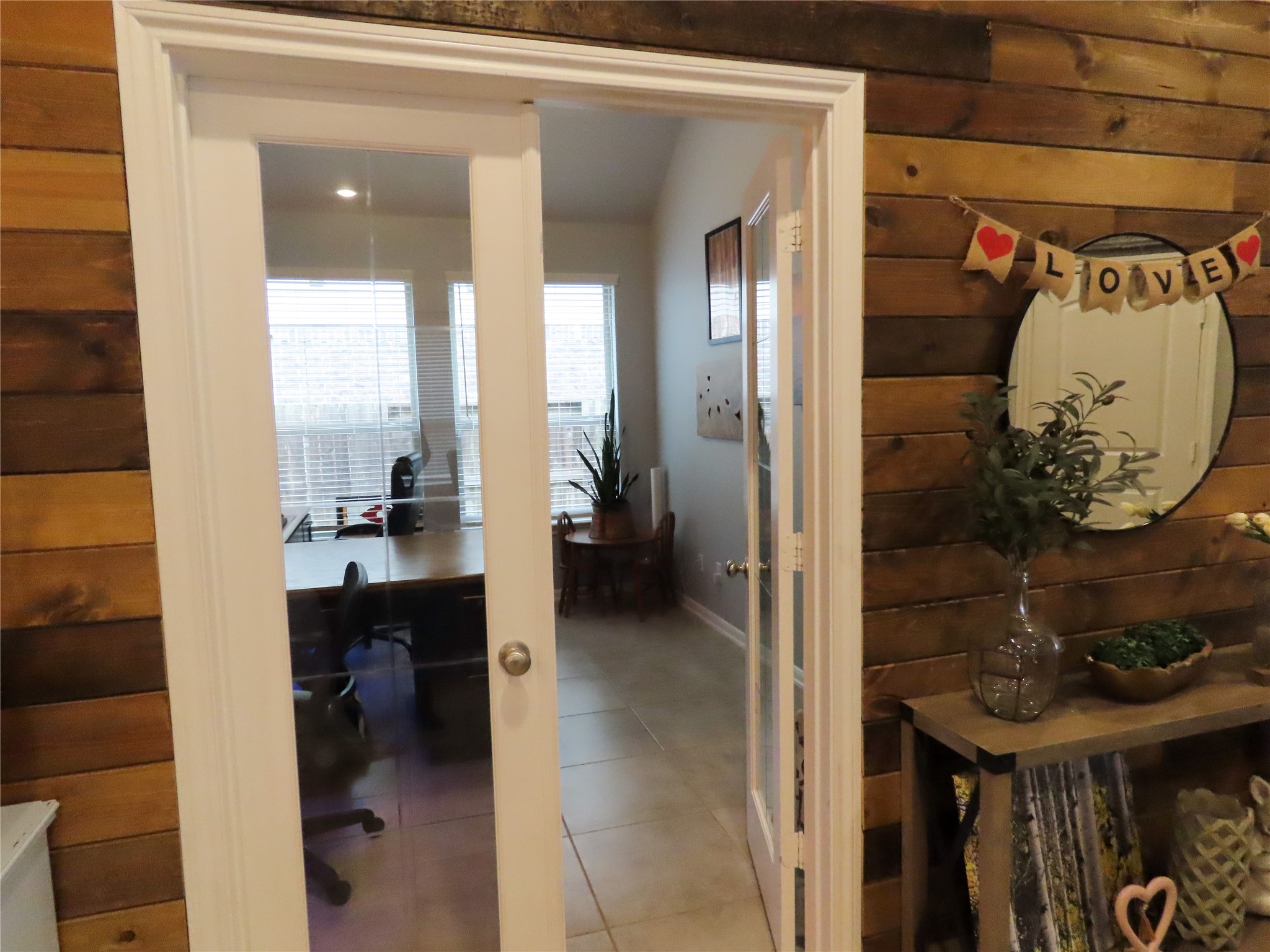 10215 Lewis Lane Iowa Colony, TX 77583 - Photo 13 of 45 Great office space, or craft area with double glass doors and oversized windows for natural light. This area is perfect for someone who appreciates ample natural illumination and versatile use.