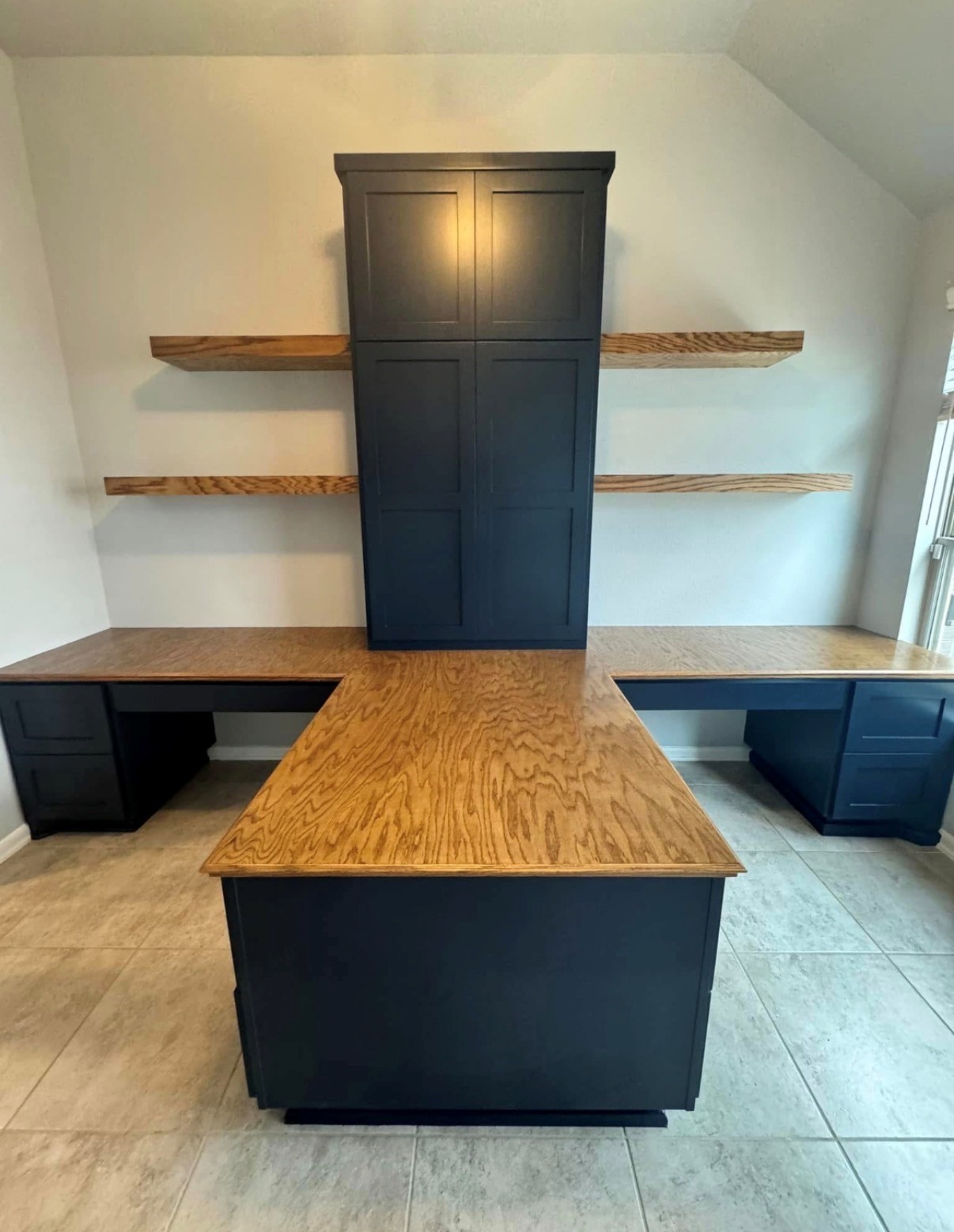 10215 Lewis Lane Iowa Colony, TX 77583 - Photo 15 of 45 New photograph of the double desk, featuring a built-in design within the office, offering ample workspace, storage, and shelving. The unit includes soft-close drawers and doors.