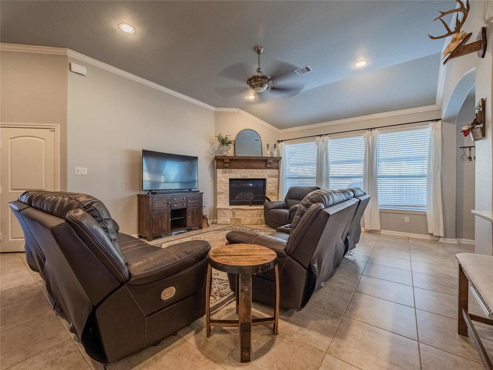 10215 Lewis Lane Iowa Colony, TX 77583 - Photo 17 of 45 Several oversized windows in the family room provide abundant natural light, complemented by crown molding and a ceiling fan.