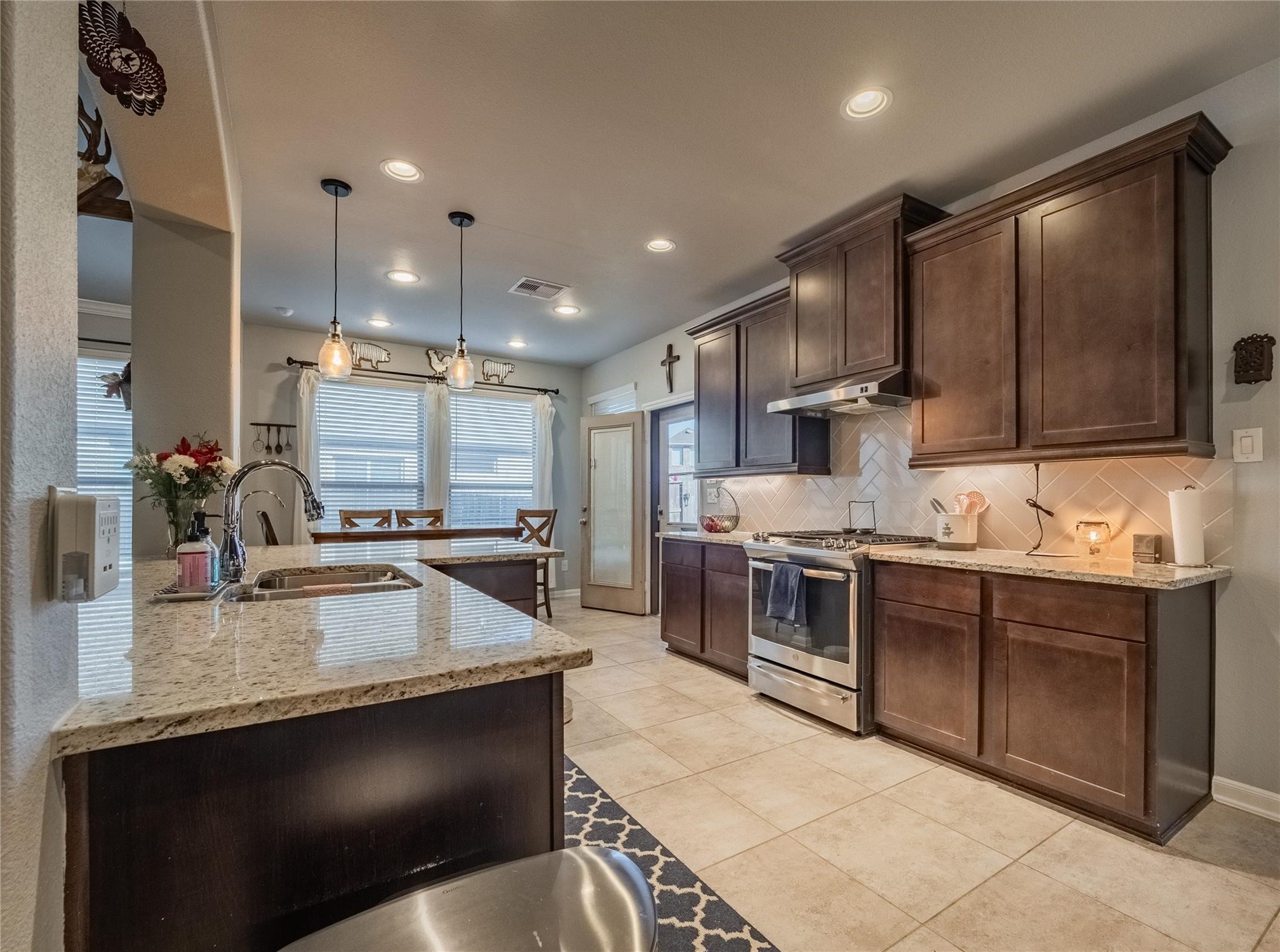 10215 Lewis Lane Iowa Colony, TX 77583 - Photo 18 of 45 a kitchen with stainless steel appliances granite countertop a sink a stove and a refrigerator