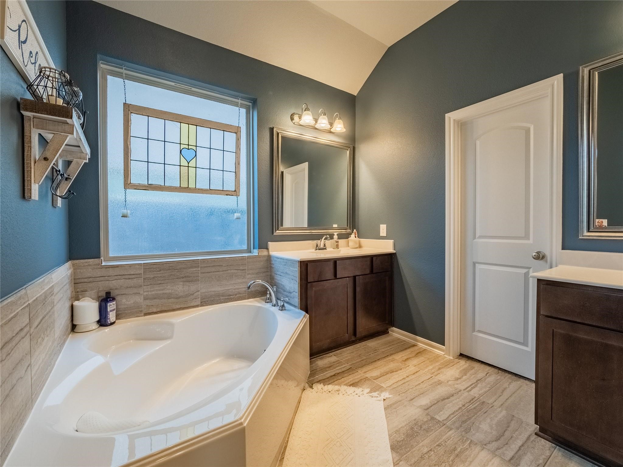 10215 Lewis Lane Iowa Colony, TX 77583 - Photo 24 of 45 a bathroom with a tub sink and mirror