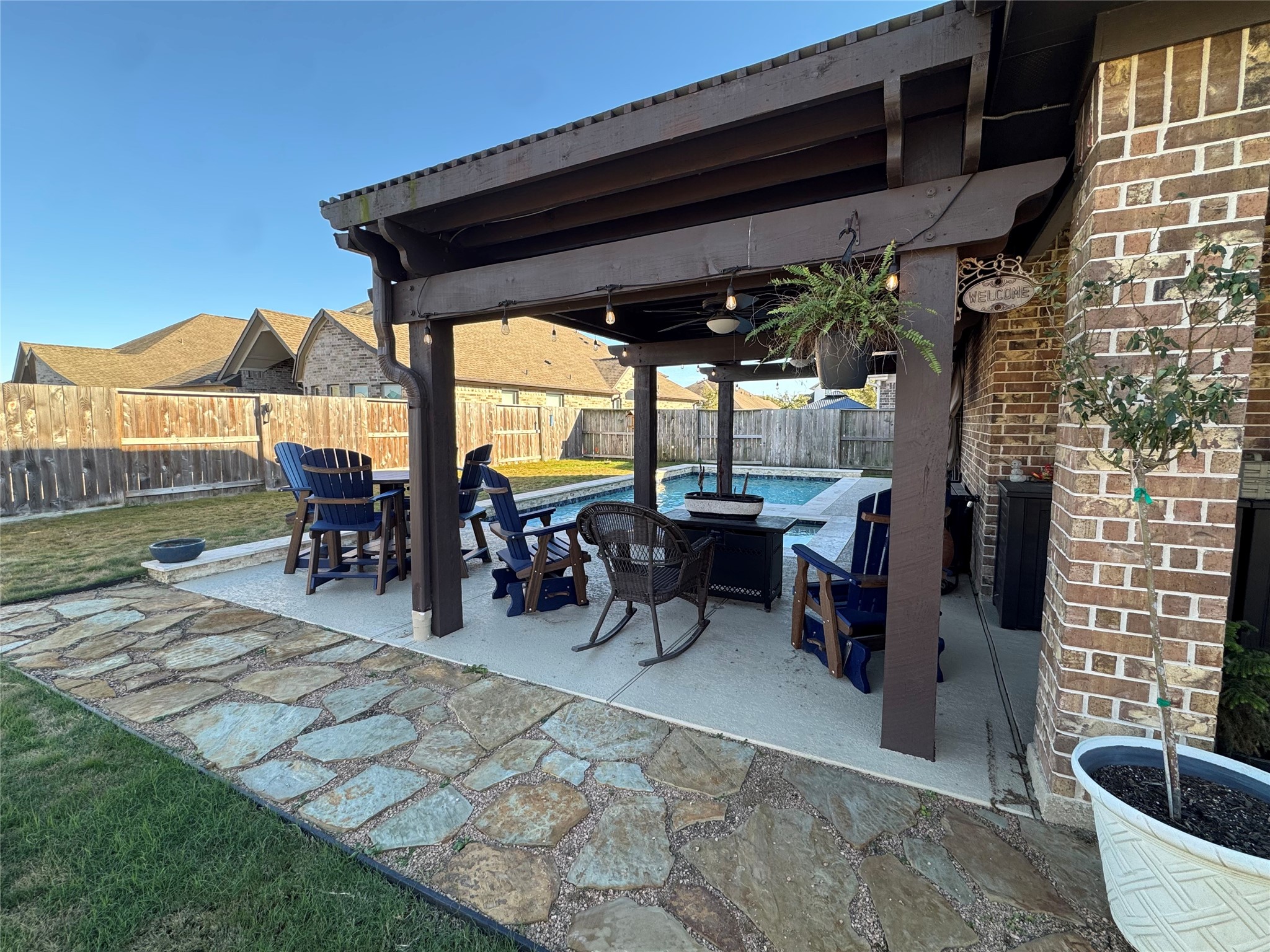 10215 Lewis Lane Iowa Colony, TX 77583 - Photo 7 of 45 a view of a patio with table and chairs potted plants with wooden floor and fence