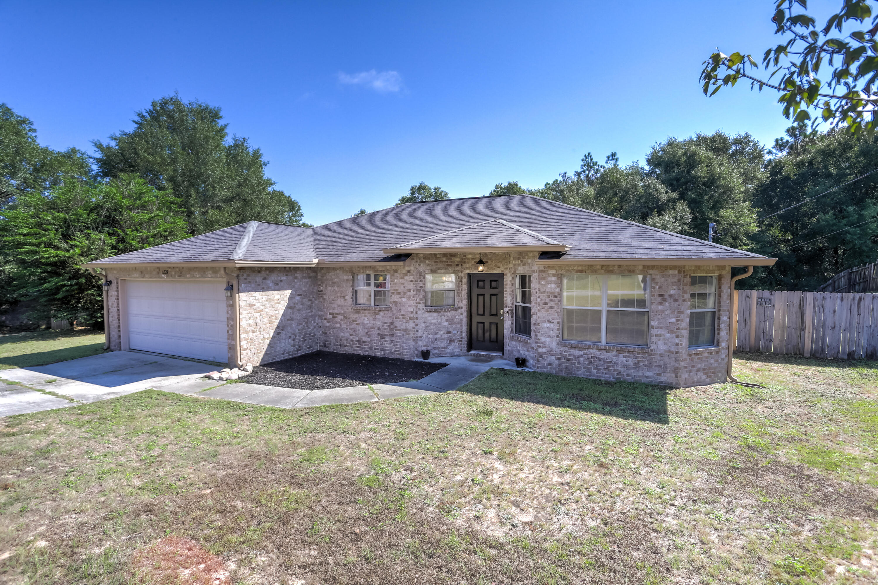 6229 Flash Lane Crestview, FL 32536 - Photo 1 of 51 a front view of a house with a yard