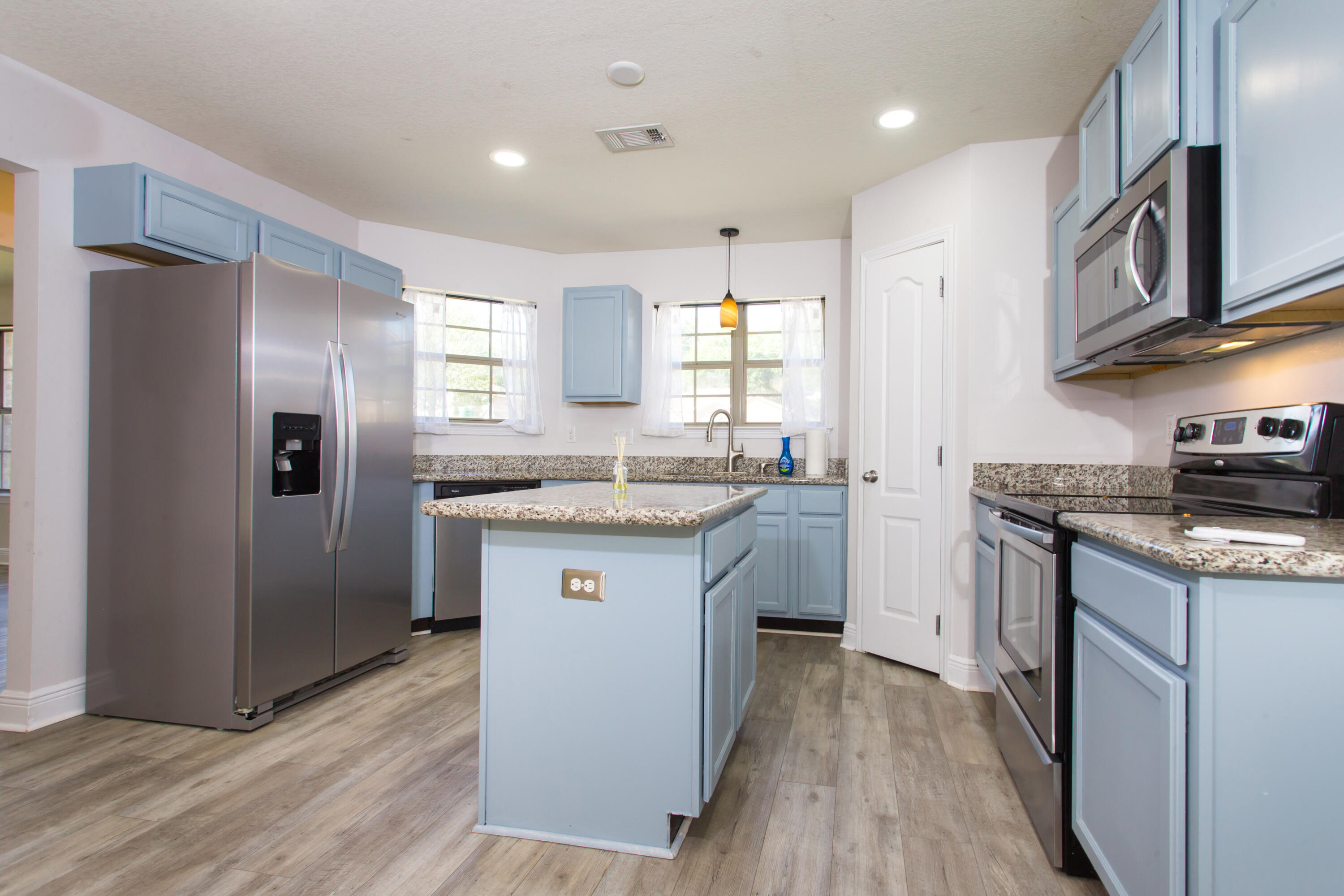 6229 Flash Lane Crestview, FL 32536 - Photo 12 of 51 a kitchen with stainless steel appliances granite countertop a refrigerator a sink dishwasher a stove with wooden cabinets and floor