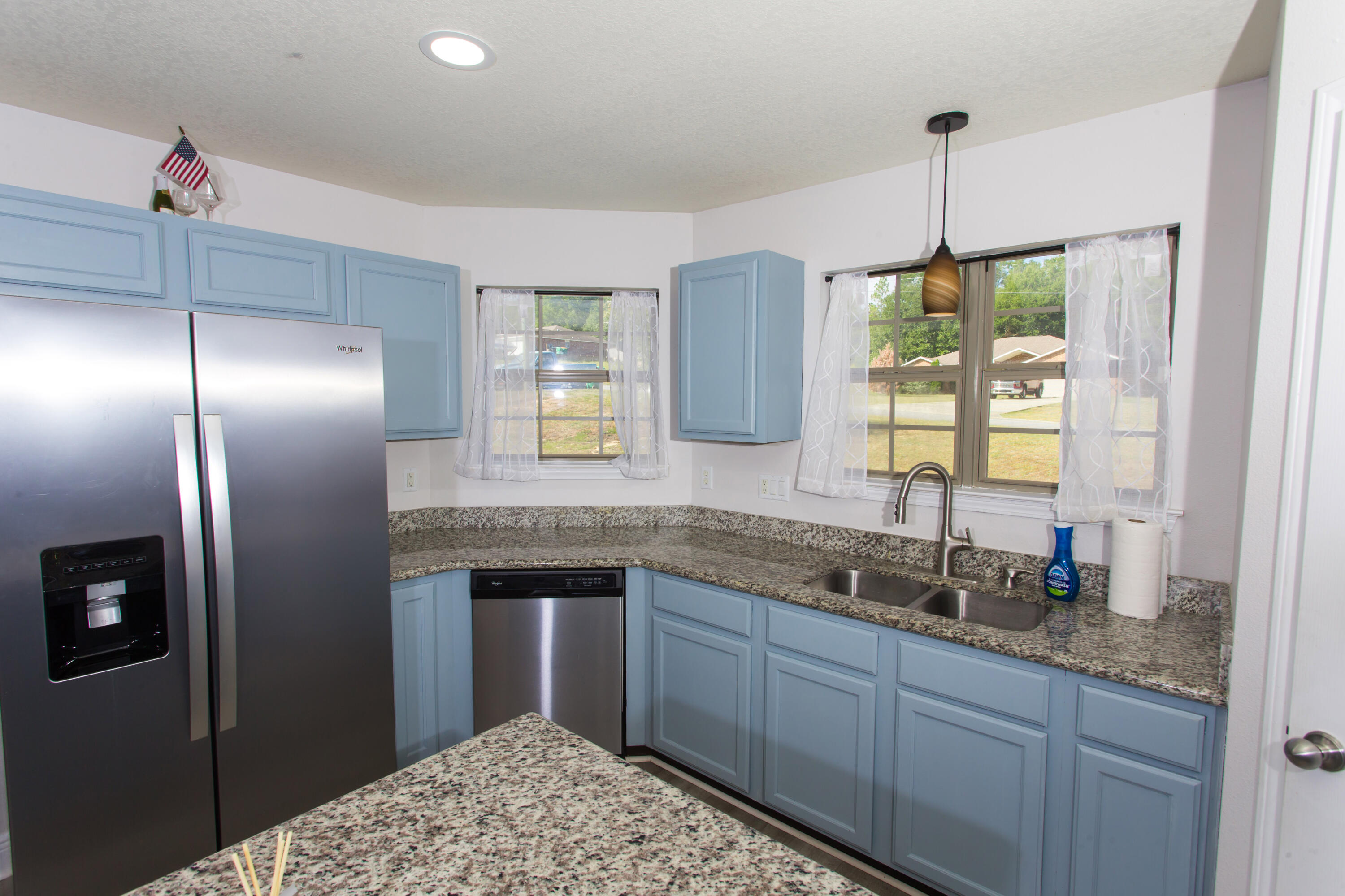 6229 Flash Lane Crestview, FL 32536 - Photo 13 of 51 a kitchen with granite countertop stainless steel appliances a sink stove and refrigerator
