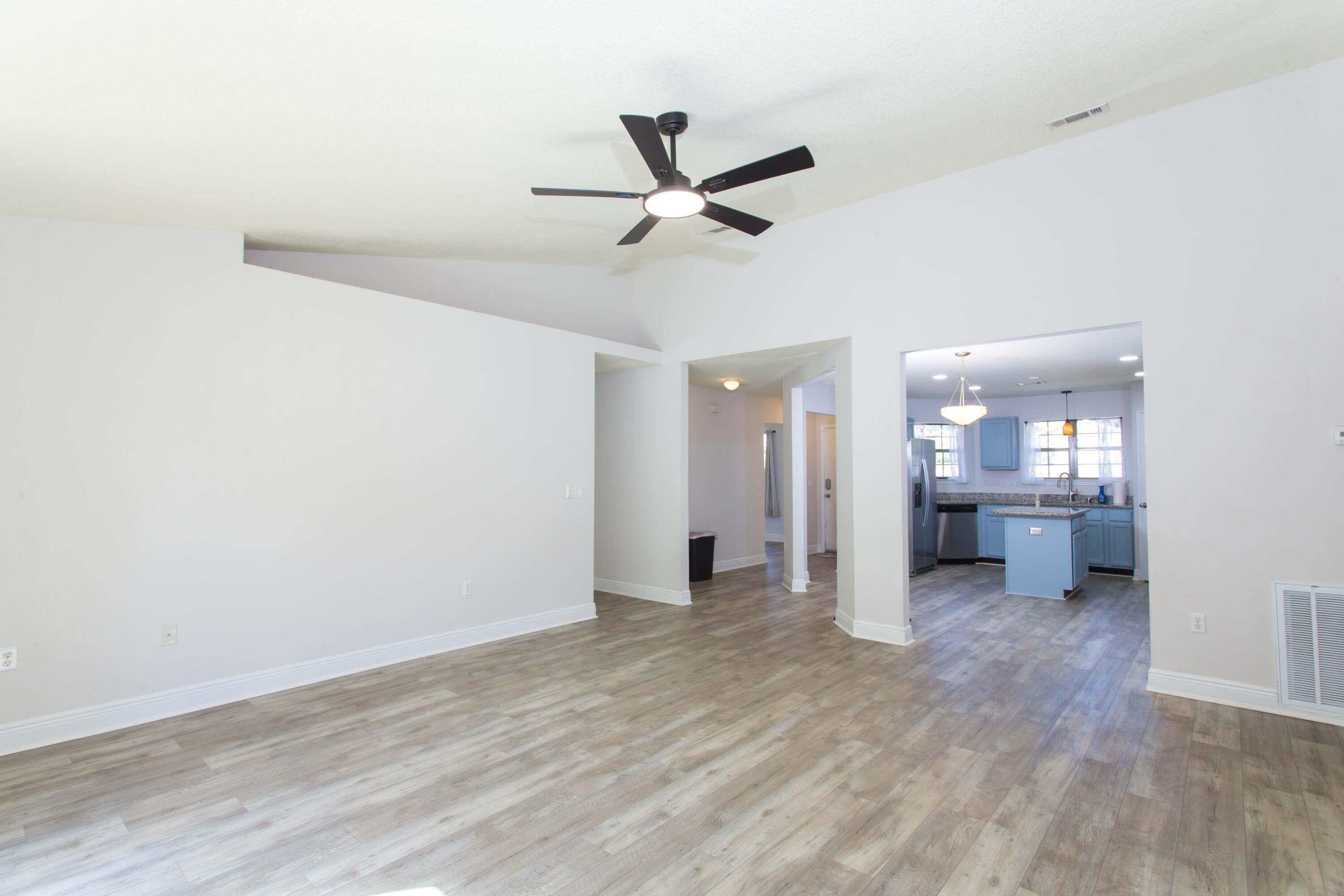 6229 Flash Lane Crestview, FL 32536 - Photo 19 of 51 a view of a room with wooden floor and a ceiling fan