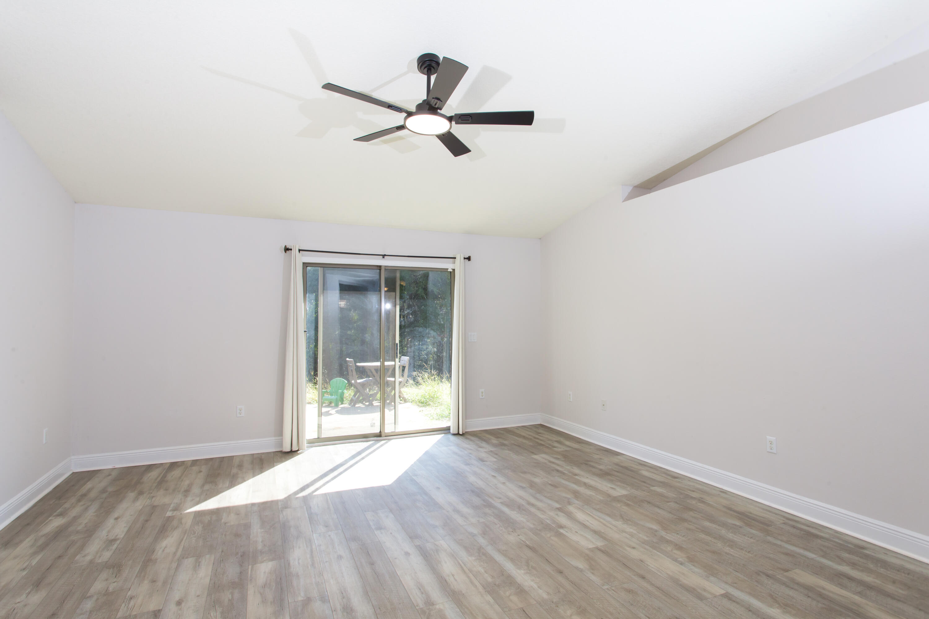 6229 Flash Lane Crestview, FL 32536 - Photo 20 of 51 an empty room with wooden floor and windows