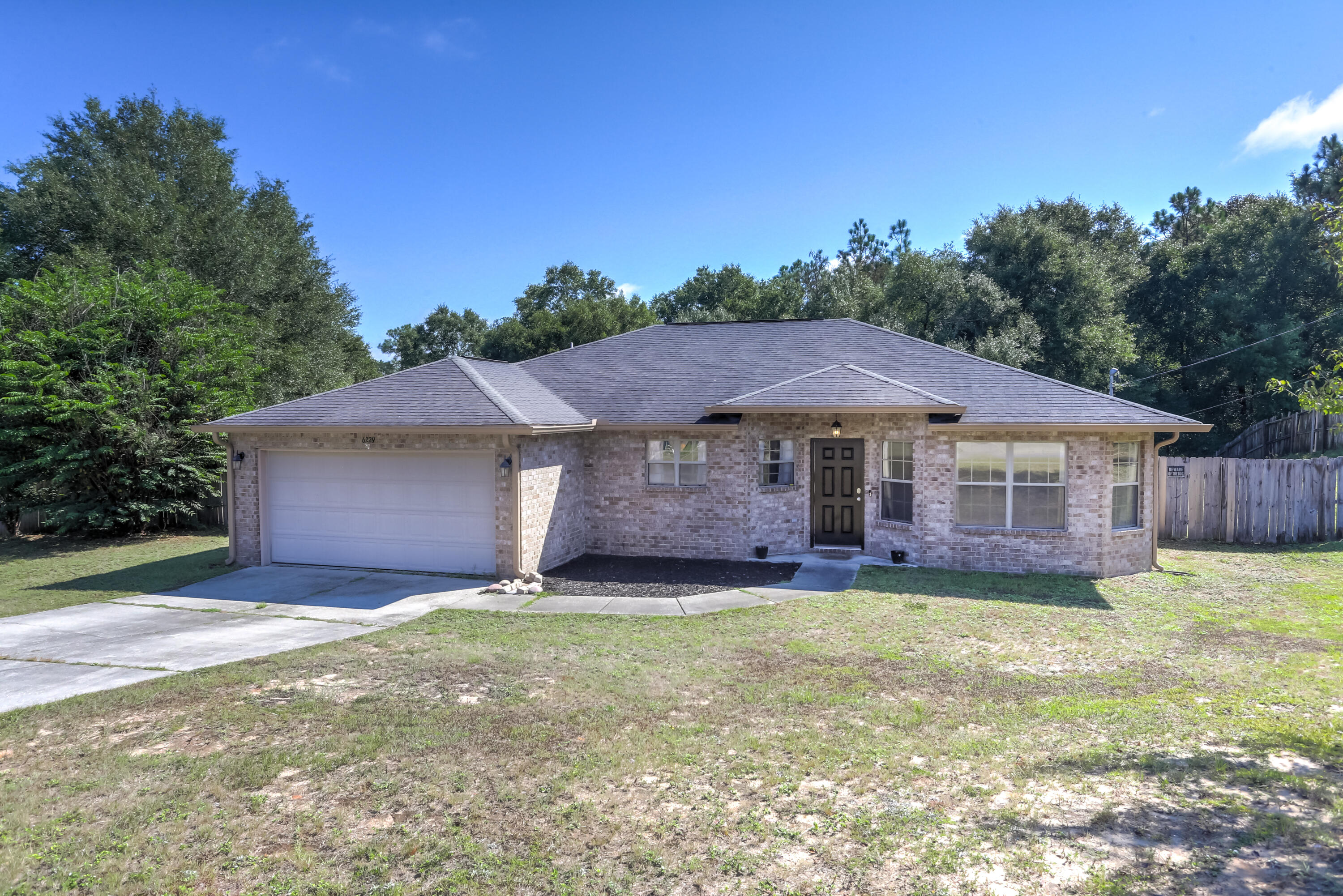 6229 Flash Lane Crestview, FL 32536 - Photo 2 of 51 a view of a house with a yard and large tree