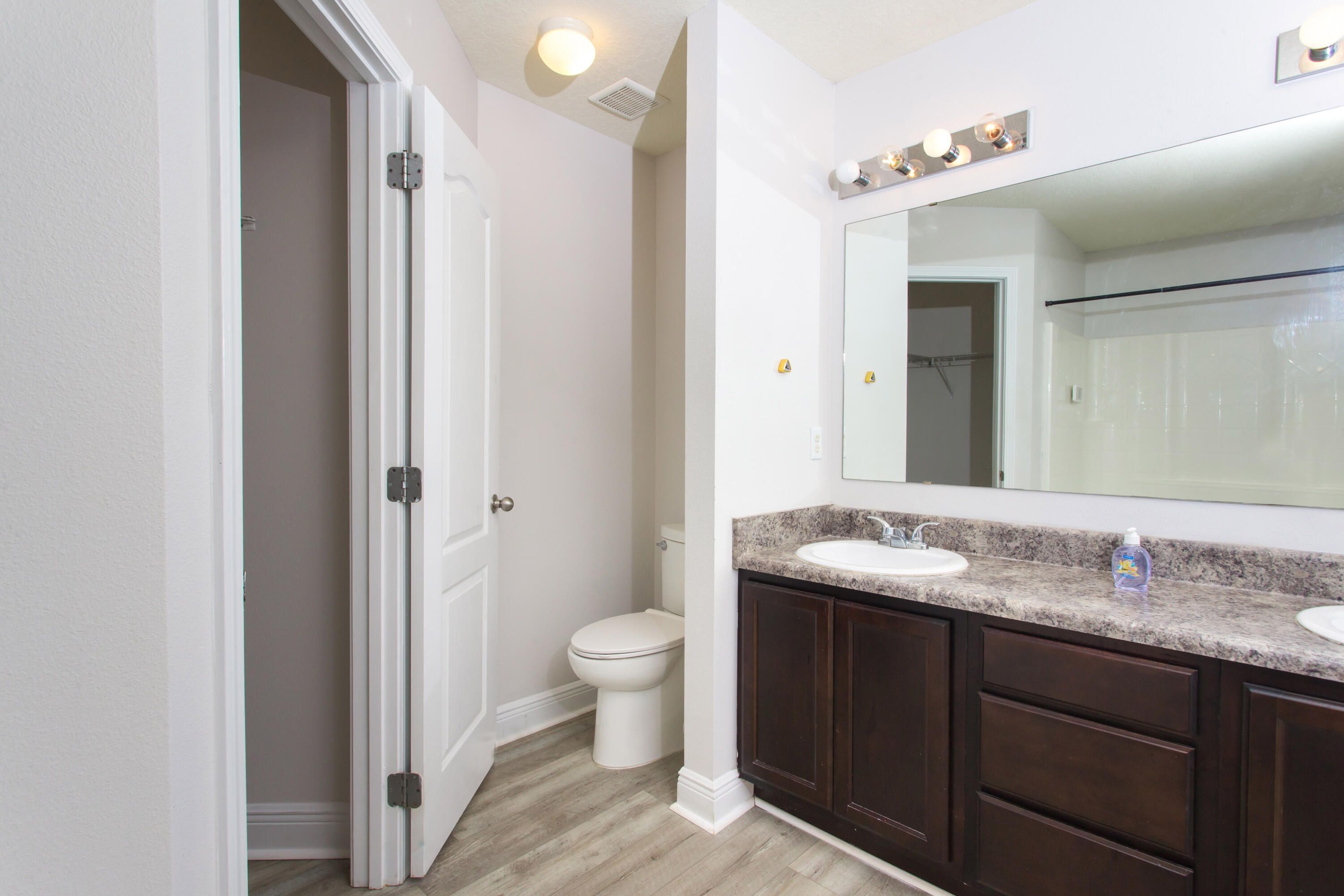 6229 Flash Lane Crestview, FL 32536 - Photo 27 of 51 a bathroom with a granite countertop sink a toilet and a mirror