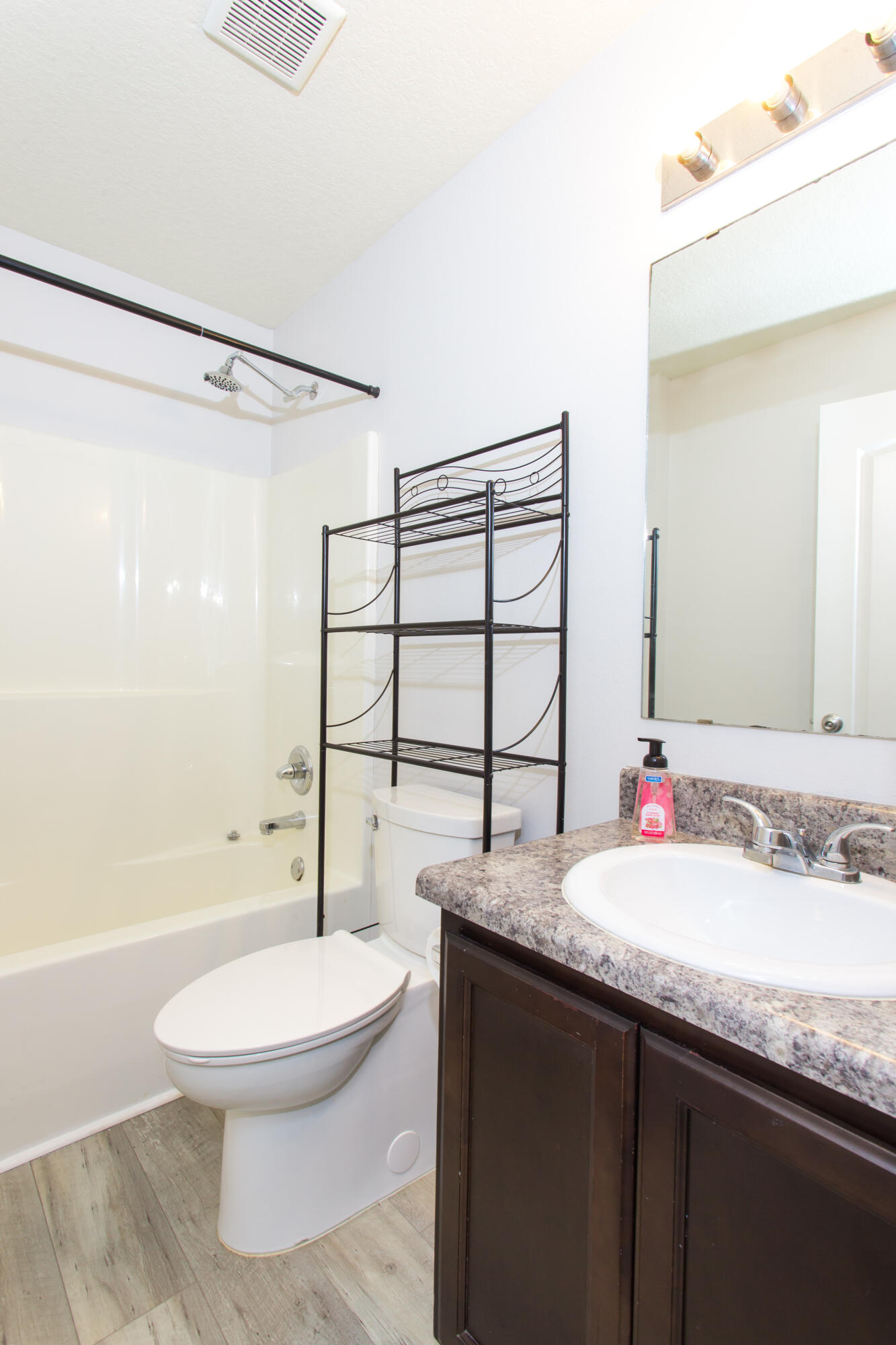 6229 Flash Lane Crestview, FL 32536 - Photo 28 of 51 a bathroom with a granite countertop sink toilet a large mirror a bathtub and shower