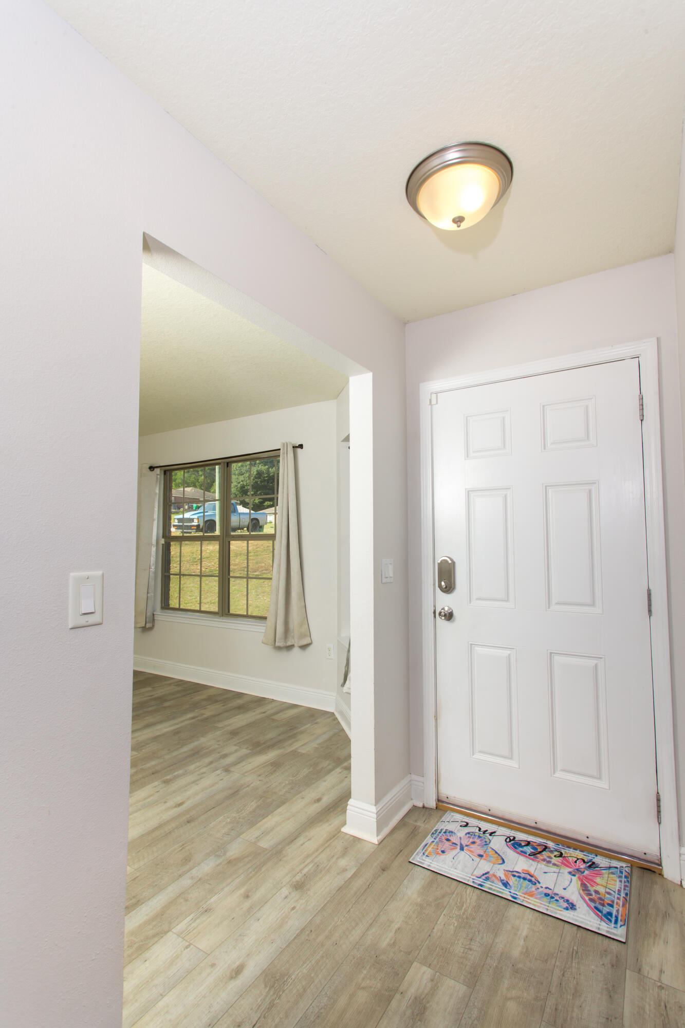 6229 Flash Lane Crestview, FL 32536 - Photo 9 of 51 a view of an empty room with window and wooden floor