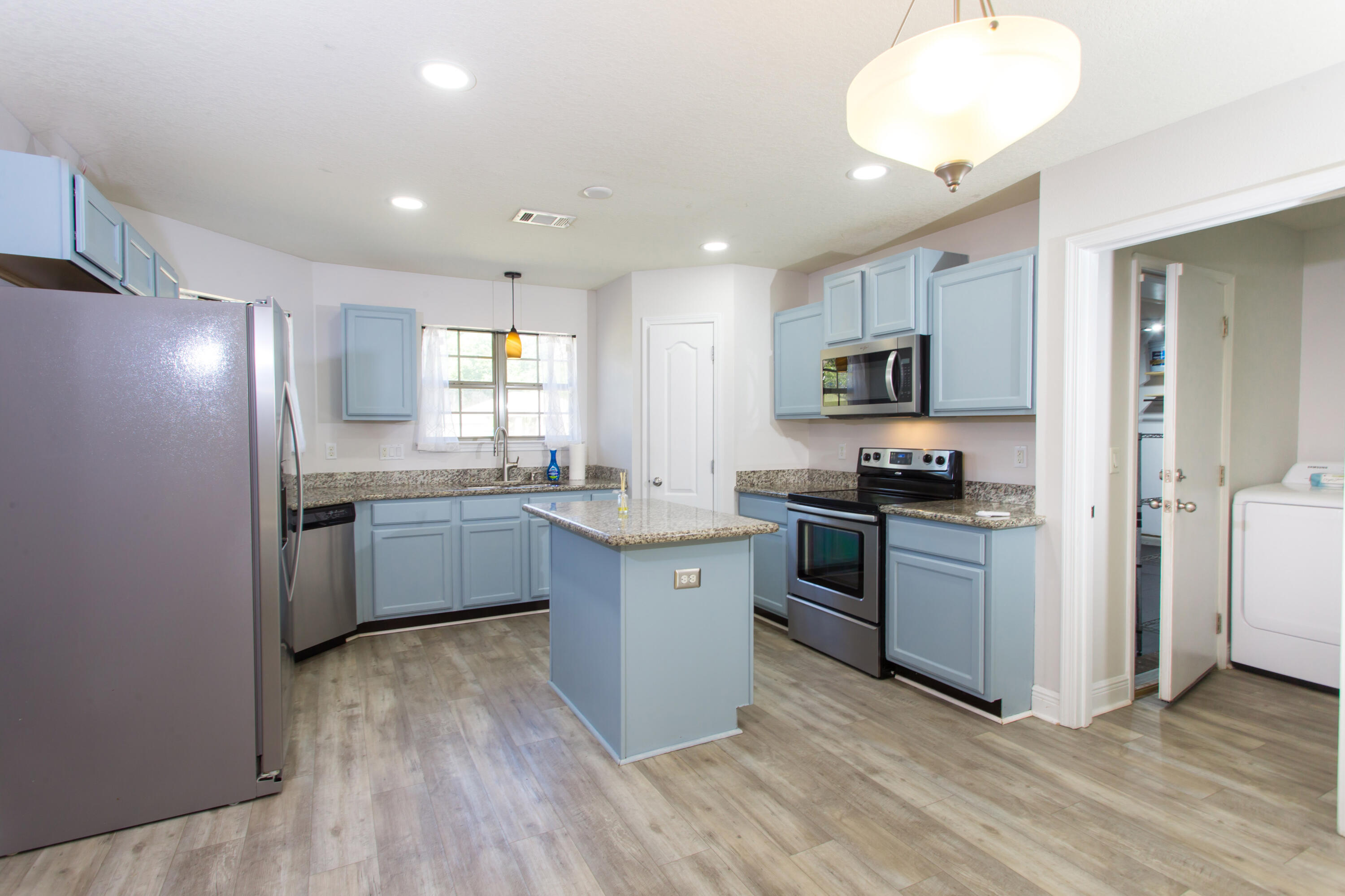 6229 Flash Lane Crestview, FL 32536 - Photo 10 of 51 a kitchen with granite countertop a refrigerator and a stove top oven