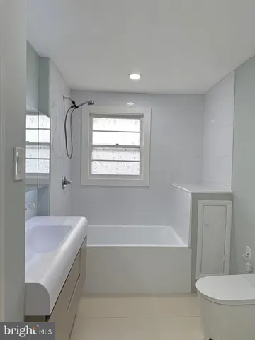 a bathroom with a bathtub and a toilet