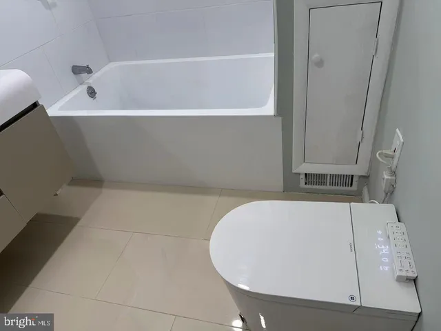 a white bath tub sitting in a bathroom