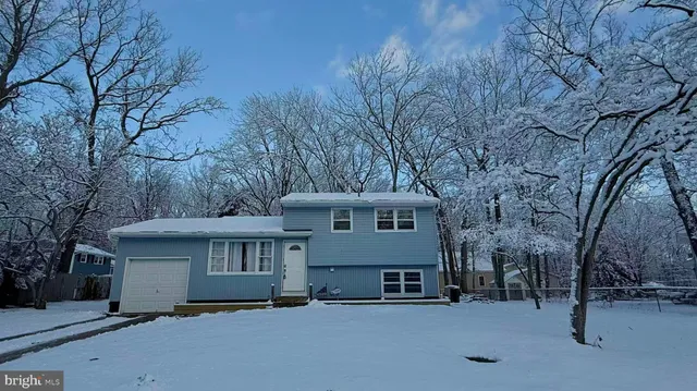 a view of a house with a snow in the yard