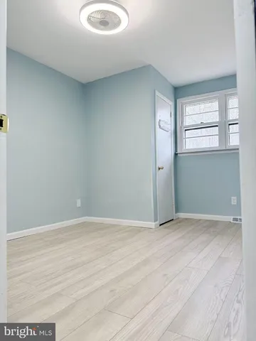 an empty room with windows and entrance