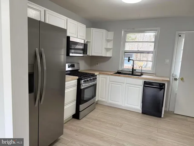 a kitchen with a refrigerator stove and sink