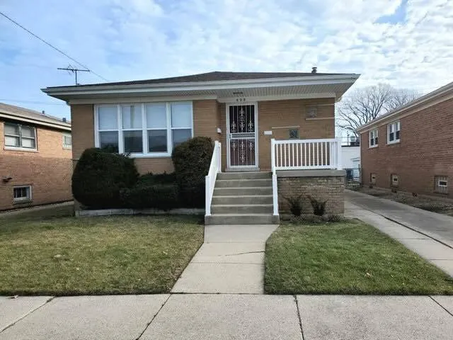 a view of a house with a yard and stairs